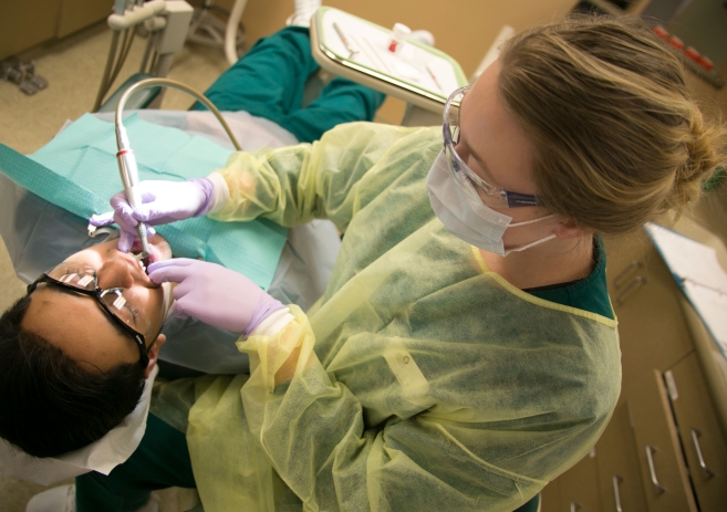 Dental assistant student practicing cleaning