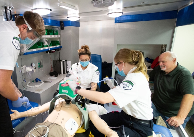 Paramedicine students with instructor in ambulance