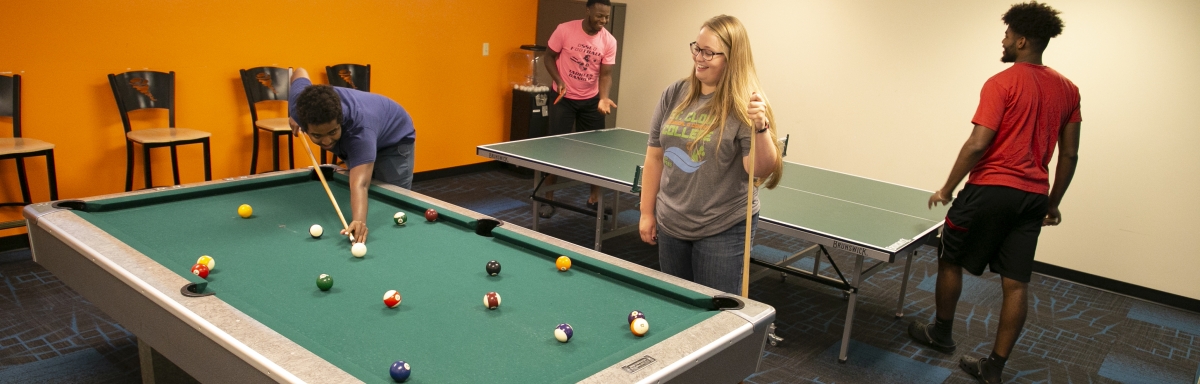 Students playing pool and ping pong