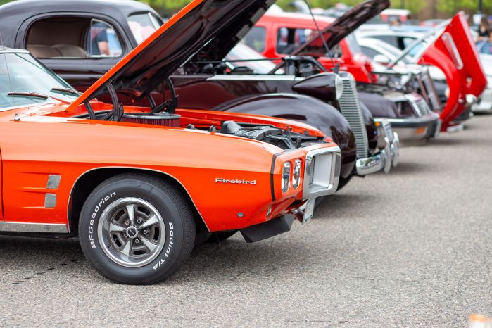 line of cars with Firebird at the front of the frame