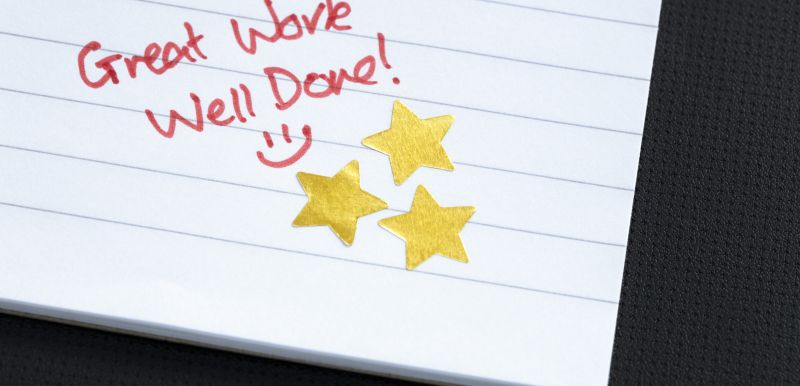 Great work, well done! on notebook paper with gold stars