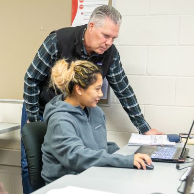 Architecture student with intructor at computer