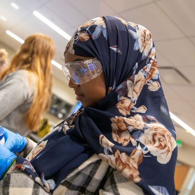 Student looking at petri dish