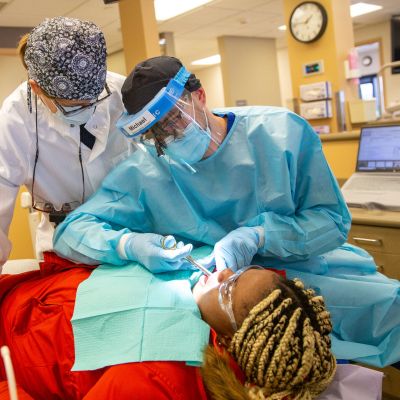 Dental Hygiene student practicing on patient