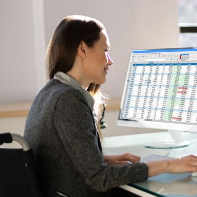 Woman in wheelchair with spreadsheets