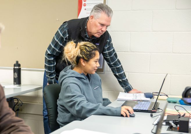 Architecture student with intructor at computer