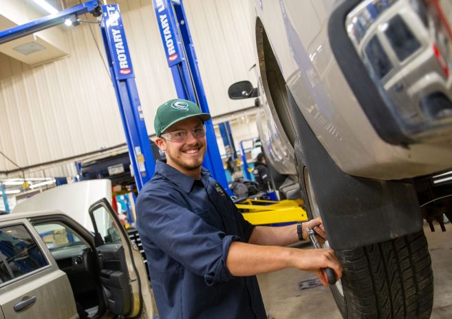 Auto student working on tire