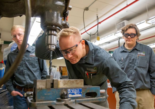 Energy and Electronics students using drill