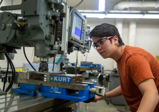 Student using machine tool equipment