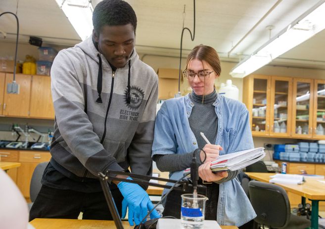 WETT students wtih beaker and notebook