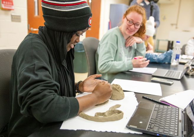 Student with clay in art class