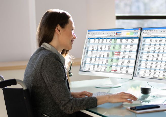 Woman in wheelchair with spreadsheets