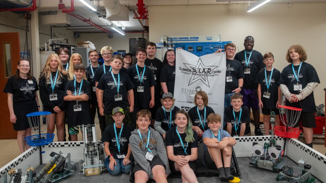 STAR campers formal group photo holding sponsor banner