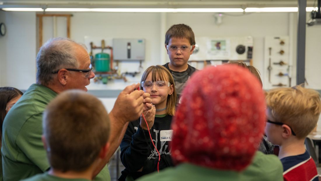 campers gathered in a group, learning about wiring