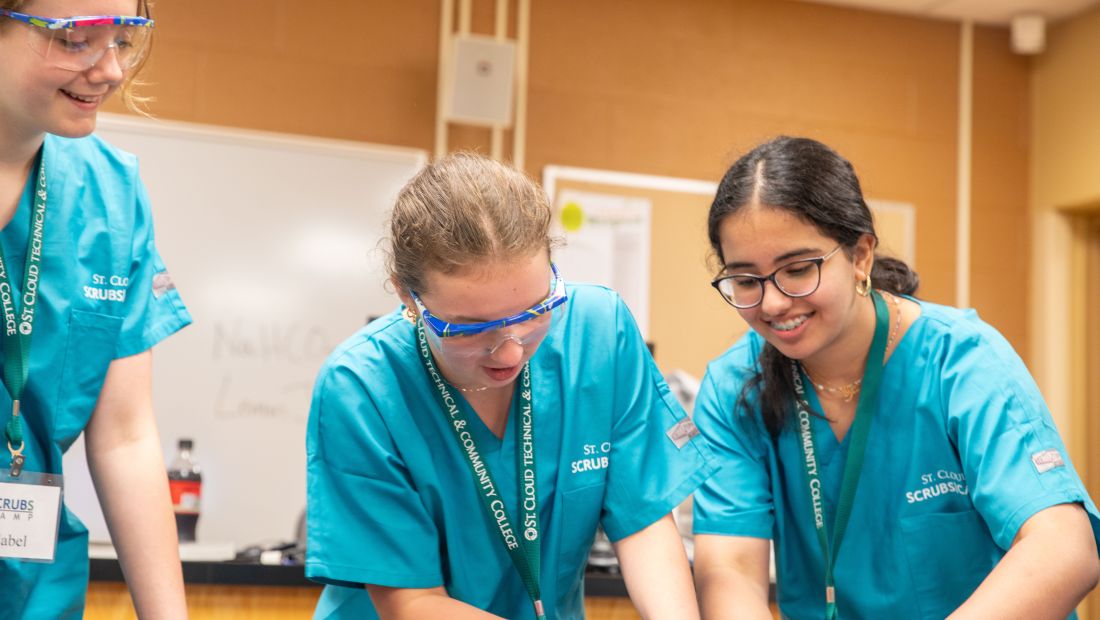 Students working on a dissection, specimen out of frame