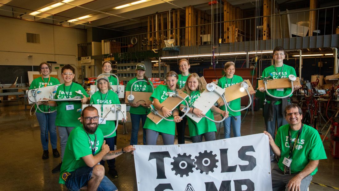Tools Campers and instructors holding sign and projects