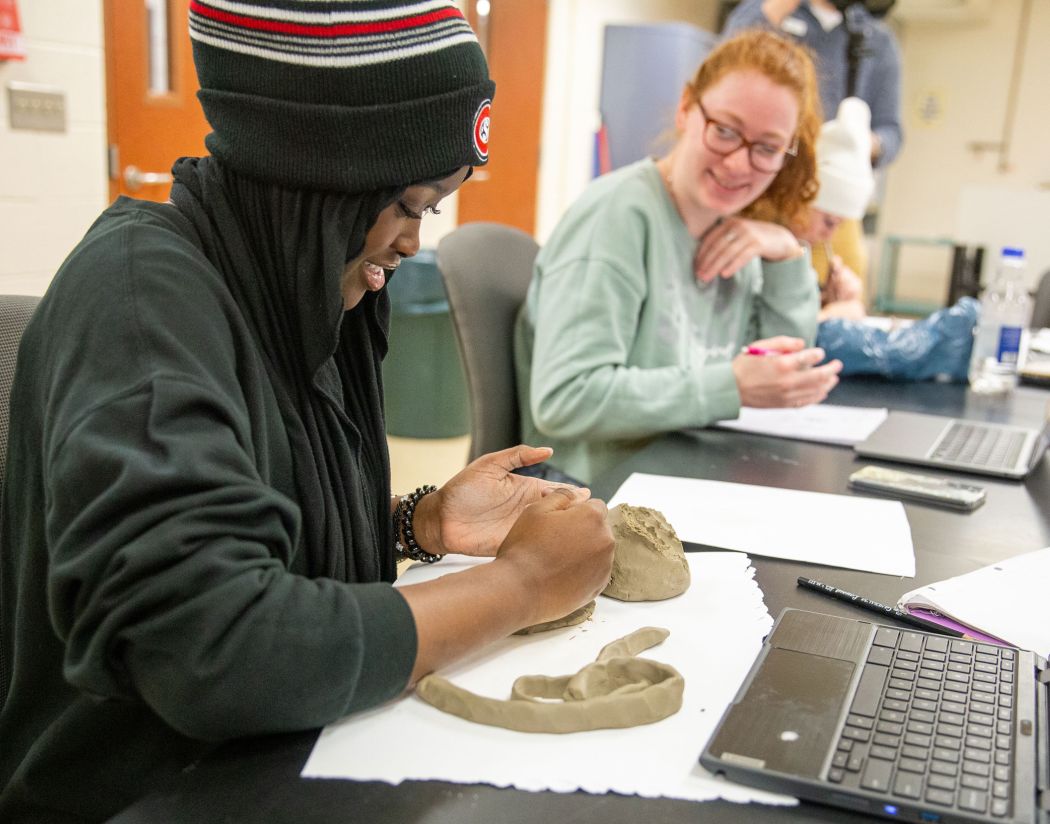 Student with clay in art class