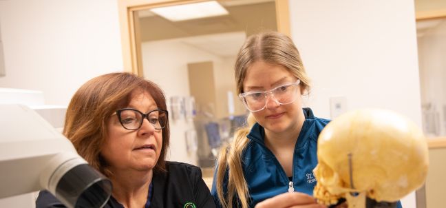 dental instructor showing student how to set up for xray