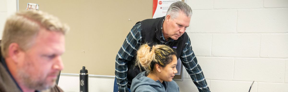 Architecture student with intructor at computer