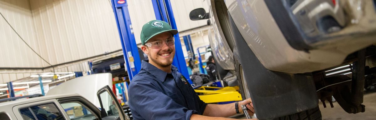 Auto student working on tire