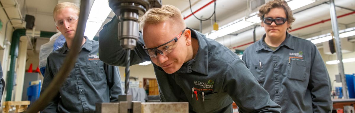 Energy and Electronics students using drill