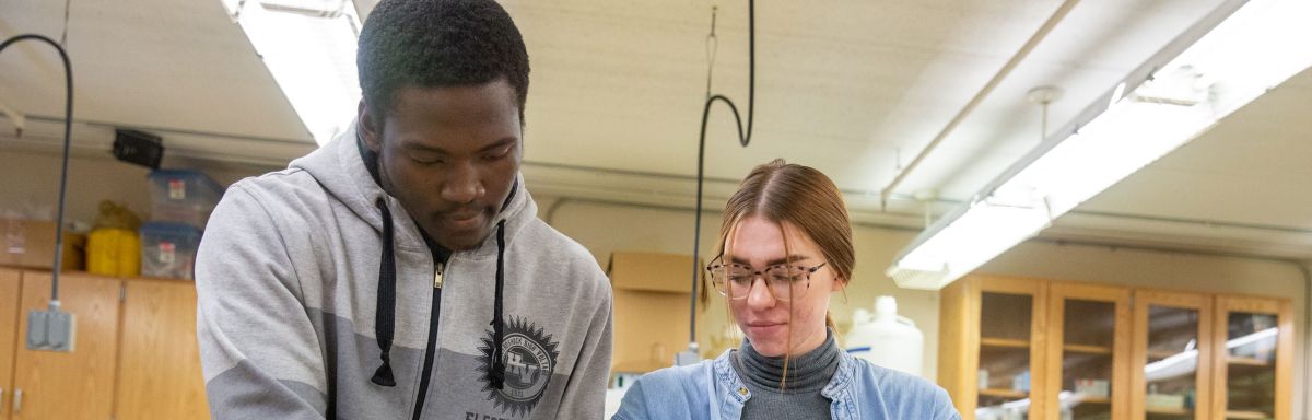 WETT students wtih beaker and notebook