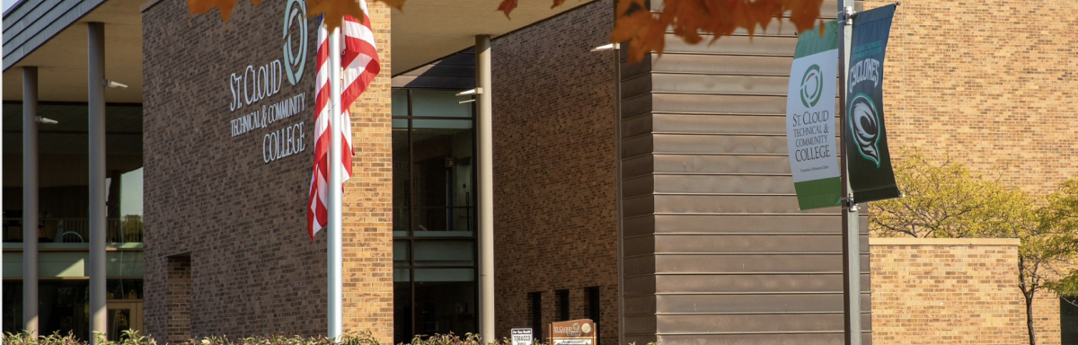 Front of SCTCC in fall with students stepping on sidewalk
