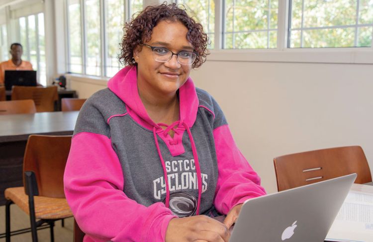 Woman sitting at desk with laptop