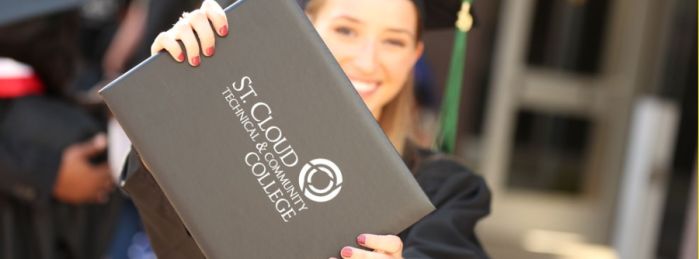 Graduate holding diploma