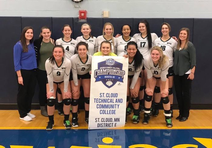 Volleyball team with tournament banner