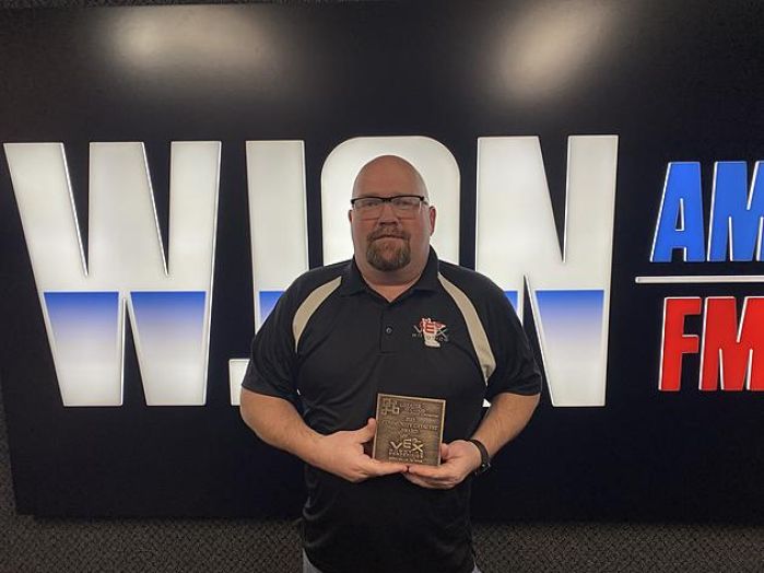 Aaron Barker holding award