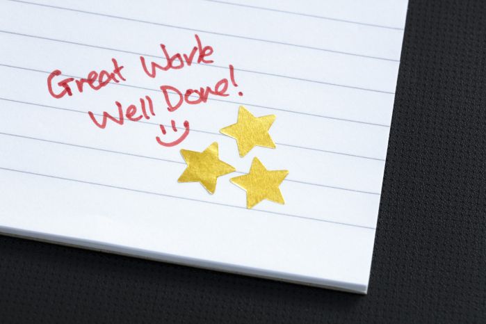 Great work, well done! on notebook paper with gold stars