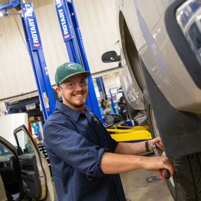 Auto student working on tire