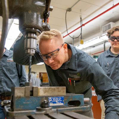 Energy and Electronics students using drill