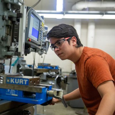 Student using machine tool equipment