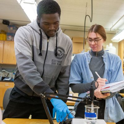 WETT students wtih beaker and notebook