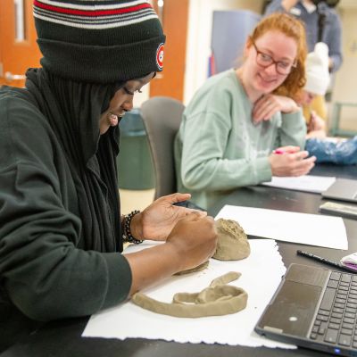 Student with clay in art class
