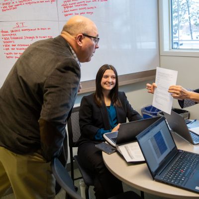 Business students talking with instructor