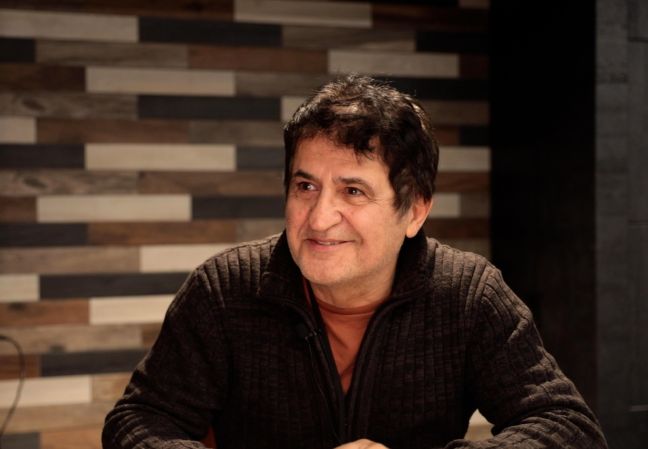 Soheyl Missaghi at a table and smiling