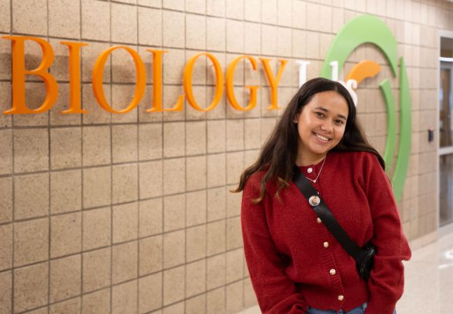 Suddhata KC in front of the SCTCC biology sign