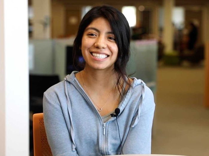 Berenice smiling at camera, sitting at table