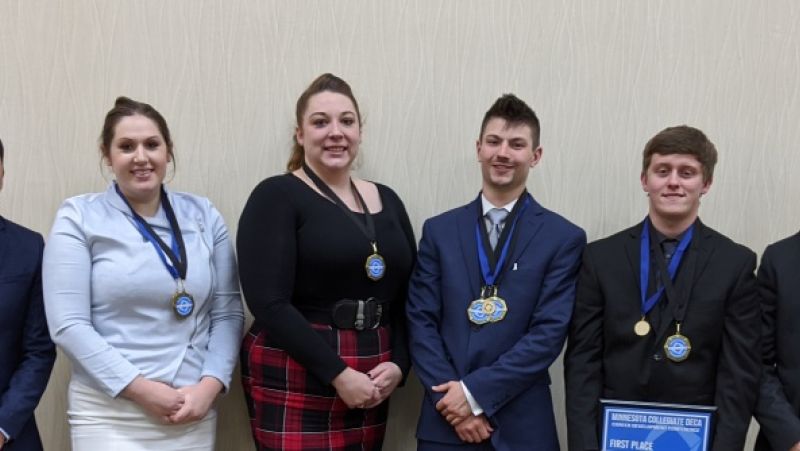 Six students at DECA sporting medals