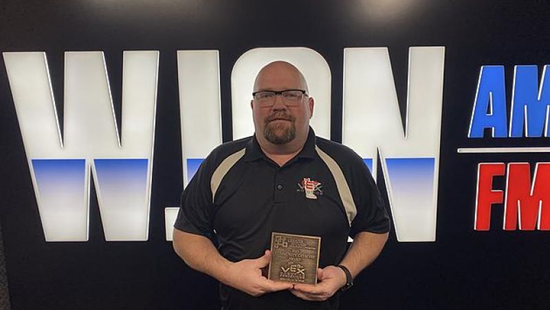 Aaron Barker holding award