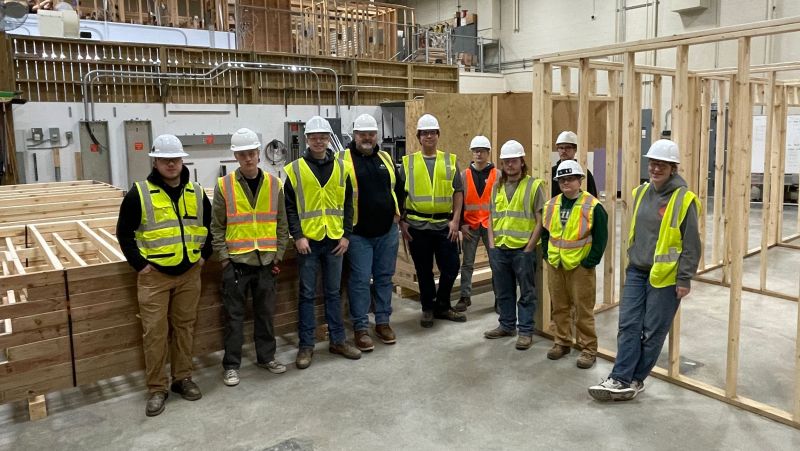 Carpentry students with lumber