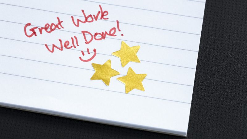 Great work, well done! on notebook paper with gold stars