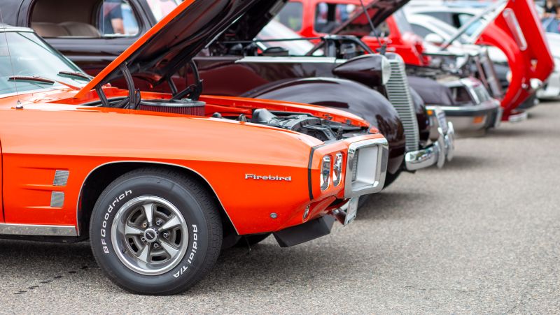 line of cars with Firebird at the front of the frame