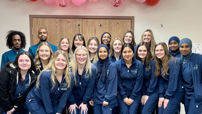 Dental students in three rows posting for camera