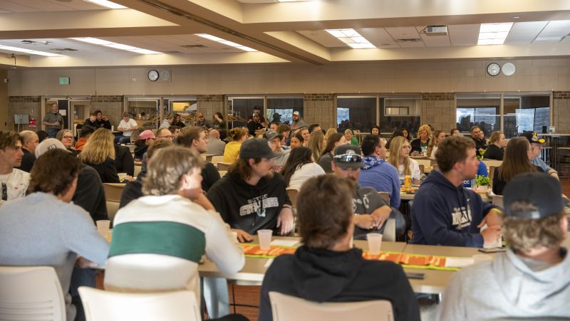 Crowd sitting at tables in the Commons for the event