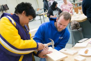 student hammering carpentry project