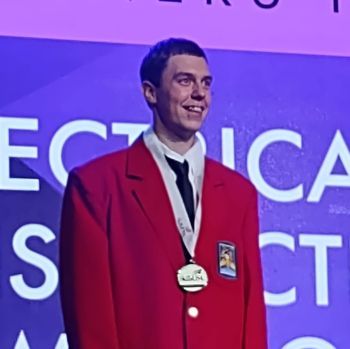 Nick with red jacket and medal